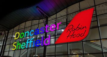 Doncaster Sheffield Airport main sign rainbow.