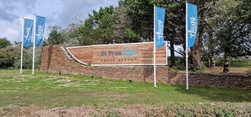 St Ives Bay main sign, stained timber background with white painted aluminium rim.
